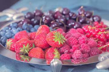 Dish with berries strawberries raspberries cherries and others