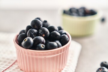  Delicious group of blueberries on ceramic bowls marble surface