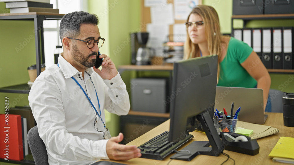 Canvas Prints Man and woman business workers using computer talking on smartphone at office