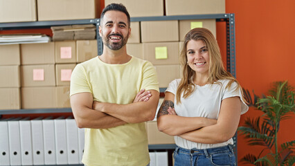 Man and woman ecommerce business workers standing together with arms crossed gesture at office