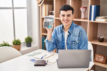 Non binary person calculating money savings looking positive and happy standing and smiling with a...