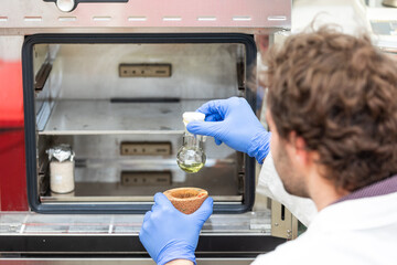 Young scientist in a research laboratory creating a scientific experiment, laboratory concept