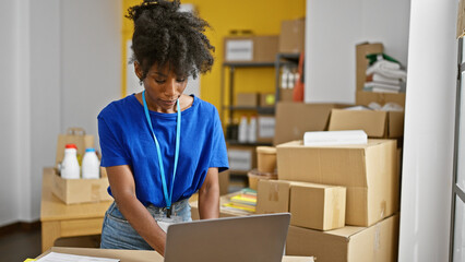 African american woman volunteer using laptop at charity center