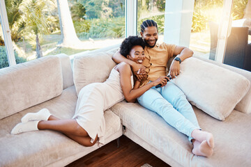 Happy, above and a black couple on the sofa, watching tv and talking in a house. Smile, love and an African man and woman with care, speaking and conversation on the living room couch for a movie