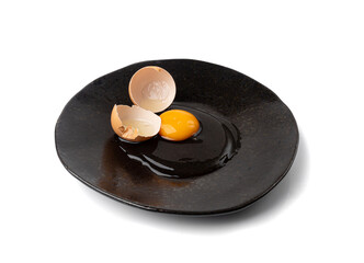 One Broken Egg in Black Bowl, Raw Yolk and White, Fresh Broken Organic Chicken Egg