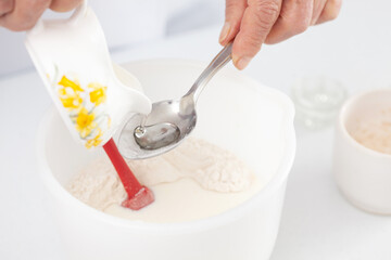 Home made pizza dough preparation. Adding oil. Pizza preparation.