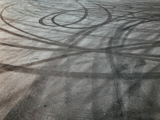 asphalt with tire marks, drifting cars, road, drifts, patterns, circles, black, curl, smoking on the road. The concept of street drift sport.