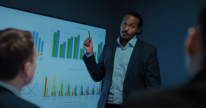 business expert presenting sales chart in office meeting, portrait of black man, 4K, Prores