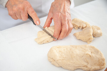 Dividing the dough to make mini pizzas. Delicious home made mini pizzas preparation.