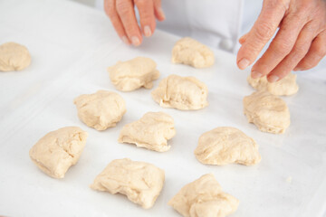 Dividing the dough to make mini pizzas. Delicious home made mini pizzas preparation.