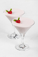 Red currant cream jelly, Panna Cotta, in a martini glass. White background. Close up
