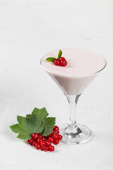 Vegan Red currant cream jelly, Panna Cotta, in a martini glass. Dark background. Copy space