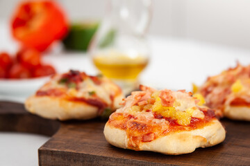 Delicious just baked homemade mini pizzas. Hawaiian pizza.