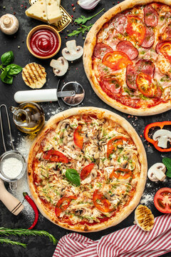pizza set on a dark background, Fast food lunch, vertical image. top view. place for text