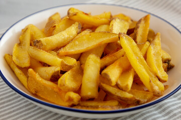 Homemade French Fries on a Plate, side view. Close-up.