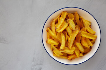 Homemade French Fries on a Plate, top view. Flat lay, overhead, from above. Copy space.