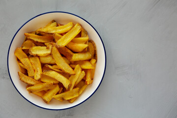 Homemade French Fries on a Plate, top view. Flat lay, overhead, from above. Copy space.