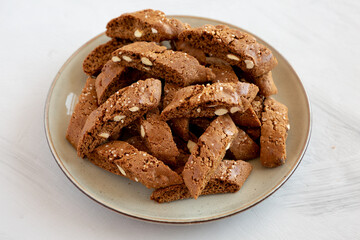 Homemade Italian Cantuccini with Almond and Coffee on a Plate on a gray surface, side view. Crispy Almond and Coffee Cookies.