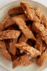 Homemade Italian Cantuccini with Almond and Coffee on a Plate on a gray surface, side view. Crispy Almond and Coffee Cookies.