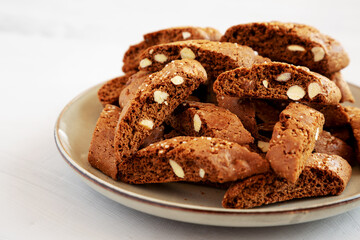 Fototapeta na wymiar Homemade Italian Cantuccini with Almond and Coffee on a Plate on a gray surface, side view. Crispy Almond and Coffee Cookies.
