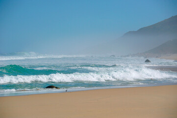  powerful cross ocean wave breaking during the day on the beach
