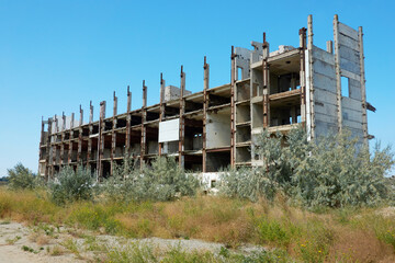 Abandoned construction. Ruins of a building with reinforced concrete frame.