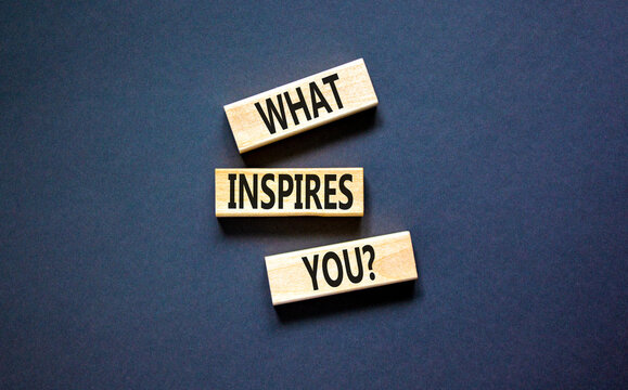 What inspires you symbol. Concept words What inspires you on wooden block. Beautiful black table black background. Business motivational what inspires you concept. Copy space.