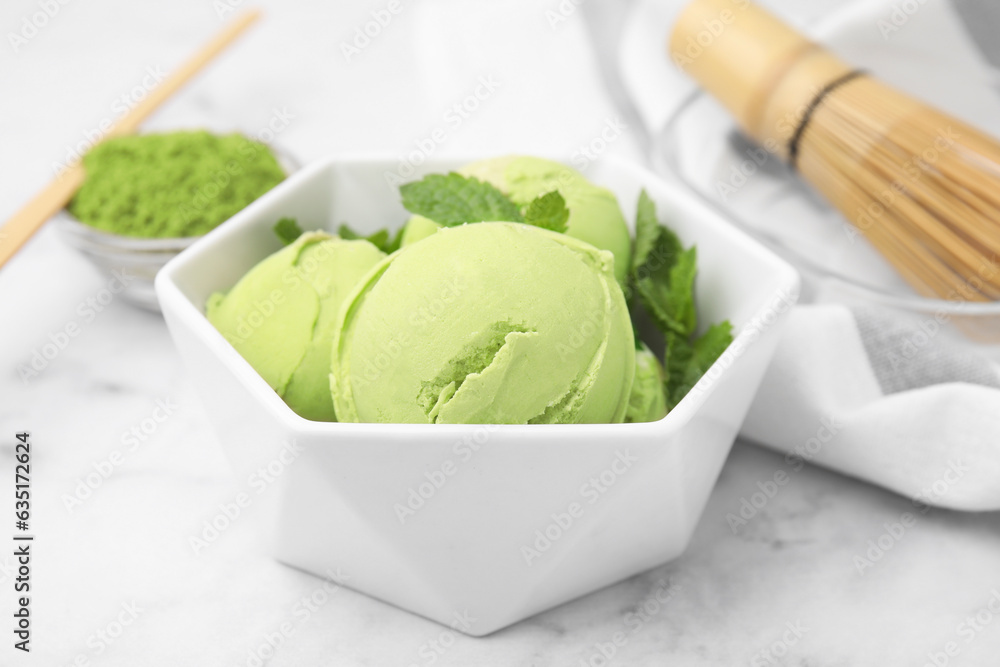 Sticker Tasty matcha ice cream in bowl on white table, closeup