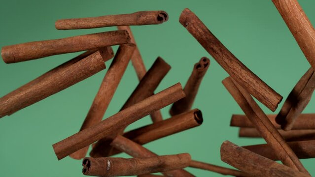 cinnamon falling on green screen in slow motion