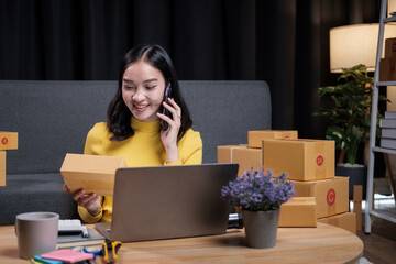 Young woman working online e-commerce shopping at her shop doing live streaming
