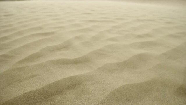 Close on sand flowing over a sand dune during sandstorm in slow motion 8K