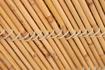 Small yellow Bamboo Sticks tied with small rope in diagonal lines