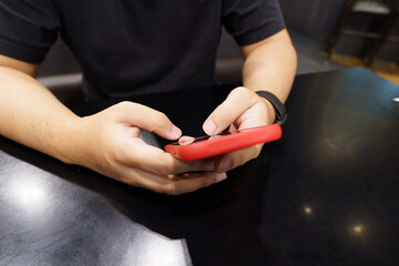 Man playing game on mobile phone. gamer boy playing video games holding Smartphone working mobile...