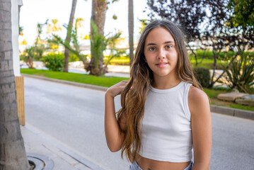 Outdoor portrait of 12 years old girl with long hair