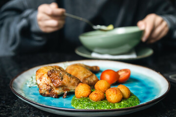 Chicken with vegetables on a plate in a cafe.