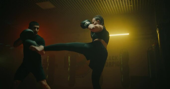 sport and healthy lifestyle, woman training with coach in fight club, practicing punches, 4K, Prores