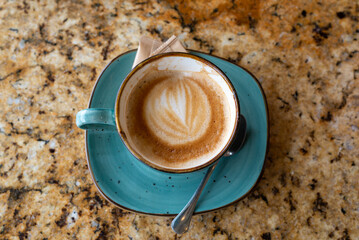 Porcelain cup of coffee or cappuccino on a table