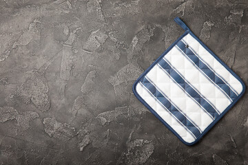 Wooden kitchen utensils, cutting board, potholder and glove on the table, top view. Kitchen Mitten...
