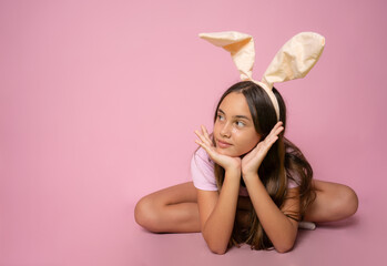 Obraz na płótnie Canvas Happy Easter holiday celebration spring concept. Young woman wearing bunny ears isolated on pink background. Preparation for holiday. Girl looking happy and excited, having fun on Easter day