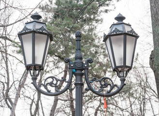 Fototapeta na wymiar A street lamp that illuminates a part of the old town.