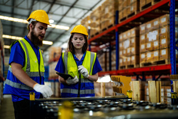 checking and inspecting metal machine part items for shipping. male and woman worker checking the...