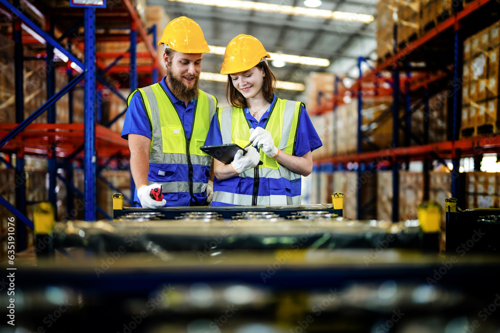 Wall mural checking and inspecting metal machine part items for shipping. male and woman worker checking the store factory. industry factory warehouse. The warehouse of spare part for machinery and vehicles.