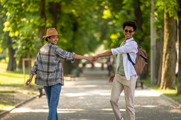 A couple walking in the park and looking excited and enjoyed