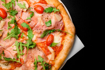 Horizontal shot of delicious pizza with meat, arugula, halved cherry tomatoes, pineapple and dried herbs