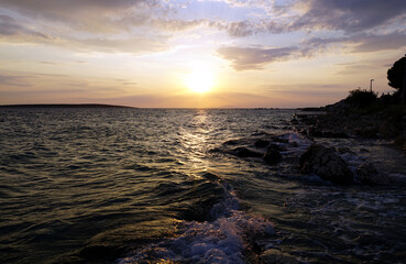 Wavy and turbulent sea surface on windy summer day sunset