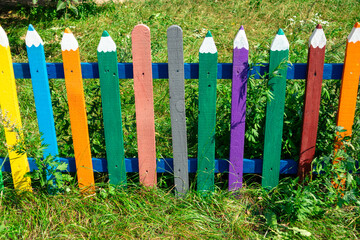 Colored wooden fence in the form of pencils