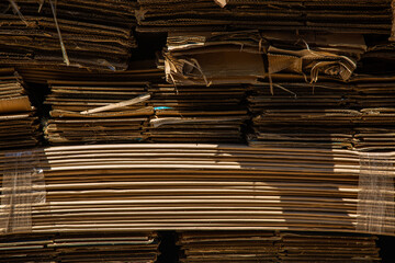 Stack of corrugated paper waste before sending to shred and recycle at recycling plant. Corrugated fiberboard.  Old, randomly folded paper.