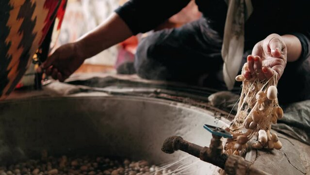 Boiling silkworm cocoons by boiler to make silk thread. Traditional silk production. Silk worms being separated from cocoons in silk factory