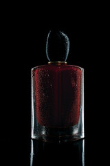 perfume in a glass bottle on a black background