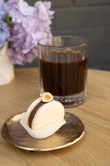 Macaroon on a wooden cafe table on flowers background